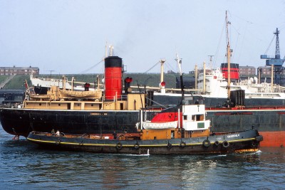 GEORGE V (built 1915, rebuilt 1954) accompanying a collier in River Tyne passing ROWANMORE in May 1970 - Peter Fitzpatrick collection.jpg